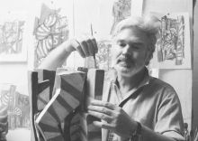 Moser painting a cardboard model for a sculpture