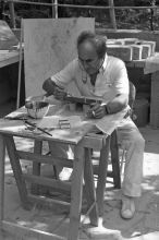 Chillida painting a clay sculpture