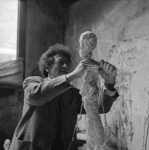 Giacometti working on a plaster sculpture
